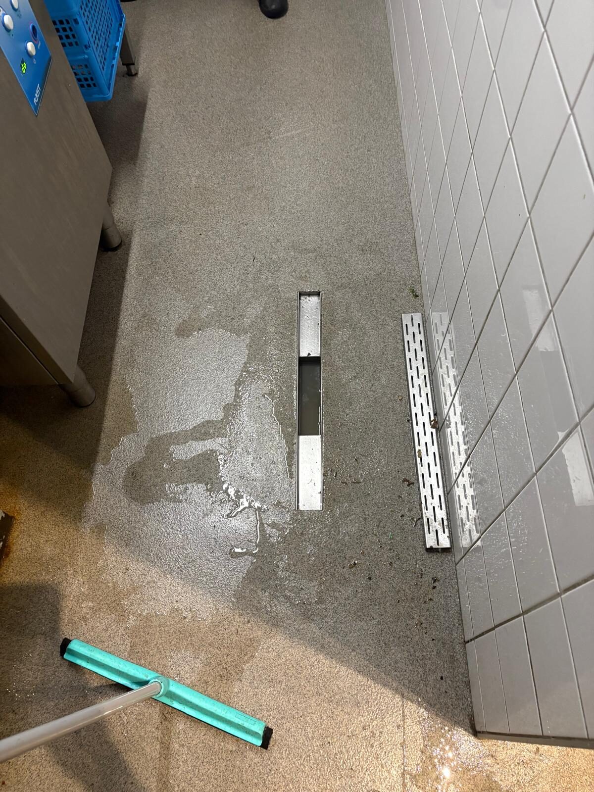 Verstopte vloergoot in bedrijfskeuken ontstopt